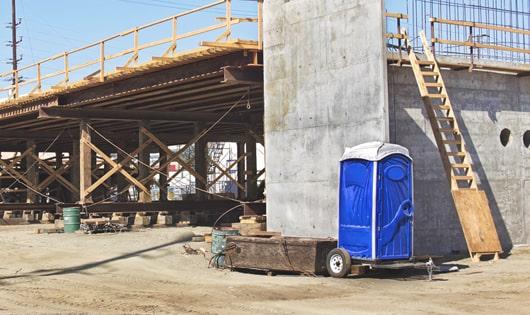 portable restrooms lined up neatly, ready to serve construction site workers